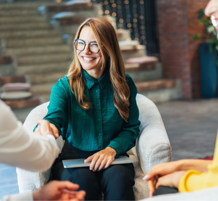 Woman smiling at an informal meeting
